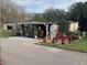 Mobile home exterior with landscaping and patio at 1960 Pinewood Ln, Mount Dora, FL 32757