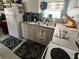 This kitchen features white cabinets, a double sink, and essential appliances at 1960 Pinewood Ln, Mount Dora, FL 32757