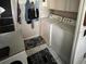 Functional laundry room with a stacked washer and dryer for space-saving convenience at 1960 Pinewood Ln, Mount Dora, FL 32757