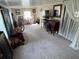 Spacious living room featuring neutral carpet, ample light, and vintage furnishings at 1960 Pinewood Ln, Mount Dora, FL 32757