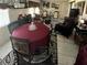 Cozy dining room and living room combination with tiled floors and dark patterned rugs at 1960 Pinewood Ln, Mount Dora, FL 32757