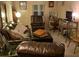Spacious living area with leather sofas and a wooden chair at 1960 Pinewood Ln, Mount Dora, FL 32757