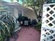 Charming patio area with comfortable seating and lush greenery for outdoor relaxation at 1960 Pinewood Ln, Mount Dora, FL 32757