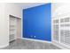 Bedroom with blue accent wall, built-in shelving, and window at 2077 Wembley Pl, Oviedo, FL 32765
