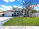 Single-Gathering home with a two-car garage and spacious front yard at 2077 Wembley Pl, Oviedo, FL 32765
