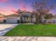 Nice curb appeal! This single-Gathering home features a two-car garage and lush landscaping at 2077 Wembley Pl, Oviedo, FL 32765