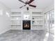 Gathering room with fireplace, built-in shelving and ceiling fan at 2077 Wembley Pl, Oviedo, FL 32765