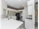 Modern white kitchen featuring stainless steel appliances and quartz countertops at 2077 Wembley Pl, Oviedo, FL 32765