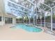 Relaxing kidney-shaped pool with screened enclosure at 2077 Wembley Pl, Oviedo, FL 32765