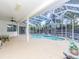 Spacious pool area with covered patio and seating at 2077 Wembley Pl, Oviedo, FL 32765