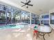 Screened pool area with patio furniture and ceiling fan at 2077 Wembley Pl, Oviedo, FL 32765