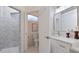 Clean bathroom with white vanity, marble shower, and separate toilet area at 2397 River Tree Cir, Sanford, FL 32771
