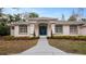 Front entrance of a two-story house with blue door, and neatly landscaped gardens at 2397 River Tree Cir, Sanford, FL 32771