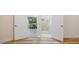 Open hallway with wood-look floors and views of dining and bath areas at 2397 River Tree Cir, Sanford, FL 32771