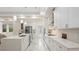 Modern kitchen with white cabinets and marble-look floors at 2397 River Tree Cir, Sanford, FL 32771