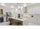 Modern kitchen with white cabinets, quartz countertops and island at 2397 River Tree Cir, Sanford, FL 32771