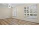 Bright living room featuring wood-look floors and plantation shutters at 2397 River Tree Cir, Sanford, FL 32771