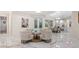 Open floor plan with marble floors, seating area, and view of the pool through French doors at 2397 River Tree Cir, Sanford, FL 32771