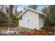 White stucco storage shed in the backyard at 2397 River Tree Cir, Sanford, FL 32771
