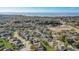 Wide aerial view of a residential community near a lake, surrounded by green space with mature trees at 264 Wallrock Ct, Ocoee, FL 34761