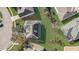 Aerial view of a home with solar panels and well-maintained lawn, surrounded by lush greenery and neighboring houses at 264 Wallrock Ct, Ocoee, FL 34761