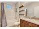 Clean bathroom with tub, granite vanity, and shelves at 264 Wallrock Ct, Ocoee, FL 34761