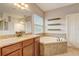 Relaxing bathroom with soaking tub, shower, and granite vanity at 264 Wallrock Ct, Ocoee, FL 34761