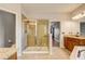 Bathroom featuring a tiled shower with glass doors, double sinks, and granite counters at 264 Wallrock Ct, Ocoee, FL 34761