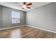 Bedroom with wood-look floors and a large window at 264 Wallrock Ct, Ocoee, FL 34761