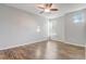 Bedroom featuring wood-look flooring, neutral walls, ceiling fan, and a window at 264 Wallrock Ct, Ocoee, FL 34761