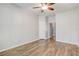 Bedroom featuring wood-look flooring, ceiling fan, and a view into the hallway at 264 Wallrock Ct, Ocoee, FL 34761