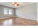 Bright bedroom featuring wood-look flooring, a ceiling fan, and a window for natural light at 264 Wallrock Ct, Ocoee, FL 34761