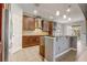 Modern kitchen with dark wood cabinets, stainless steel appliances, and a breakfast bar for casual dining at 264 Wallrock Ct, Ocoee, FL 34761