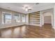 Living room with hardwood floors, ceiling fan, and a wood accent wall at 264 Wallrock Ct, Ocoee, FL 34761