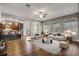 Open living area featuring a modern kitchen, hardwood floors, and ample natural light, ideal for a cozy atmosphere at 264 Wallrock Ct, Ocoee, FL 34761
