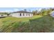 Expansive backyard with lush green grass and views of the home's back exterior at 265 Marion Oaks Mnr, Ocala, FL 34473