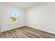 Bright bedroom features wood-look floors, a window, and neutral paint at 265 Marion Oaks Mnr, Ocala, FL 34473
