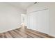Bedroom featuring wood-look flooring, white walls, and a double door closet at 265 Marion Oaks Mnr, Ocala, FL 34473
