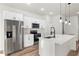 Modern kitchen with stainless steel appliances, white cabinets, and a spacious island at 265 Marion Oaks Mnr, Ocala, FL 34473