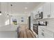 Open kitchen with stainless appliances, quartz countertops, and wood-look flooring at 265 Marion Oaks Mnr, Ocala, FL 34473