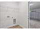 Utility room with hook ups, storage shelf and wood-look floors at 265 Marion Oaks Mnr, Ocala, FL 34473