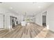 Spacious living area featuring an open-concept design, modern kitchen, and wood-look floors at 265 Marion Oaks Mnr, Ocala, FL 34473