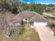Aerial view of a house, showing the front yard, driveway, and surrounding trees at 2810 Summerfield St, Deltona, FL 32738
