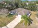 Aerial view of a single-Gathering home with driveway and surrounding trees at 2810 Summerfield St, Deltona, FL 32738