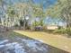 Large backyard with grassy lawn and mature trees at 2810 Summerfield St, Deltona, FL 32738