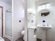 Bathroom with pedestal sink, shower, and white tile at 2810 Summerfield St, Deltona, FL 32738