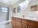 Bathroom boasts double sinks, wood cabinets, and a shower/tub combo at 2810 Summerfield St, Deltona, FL 32738