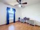 Bedroom with ceiling fan, window, and wooden laminate floor at 2810 Summerfield St, Deltona, FL 32738