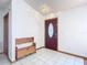 Bright entryway with tiled floors, a wooden bench, and a burgundy door at 2810 Summerfield St, Deltona, FL 32738