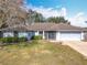 One-story house with a brown roof, attached garage, and well-maintained lawn at 2810 Summerfield St, Deltona, FL 32738